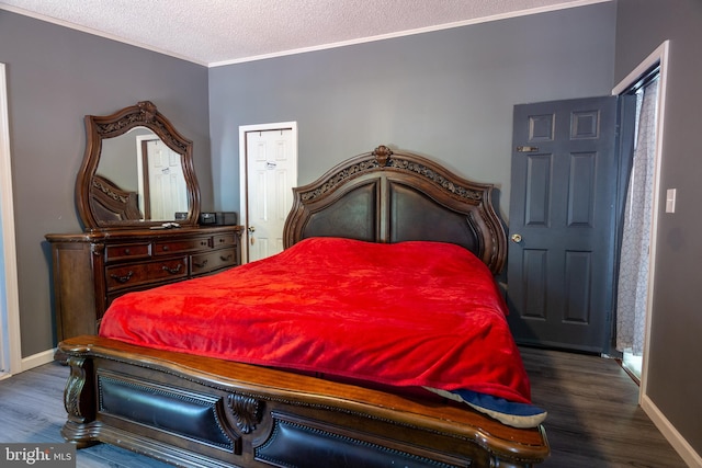 bedroom featuring crown molding, a textured ceiling, baseboards, and dark wood-style floors