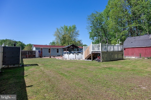 view of yard with fence, a deck, and stairway