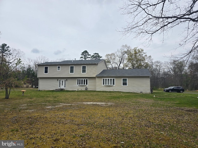 back of house with a lawn