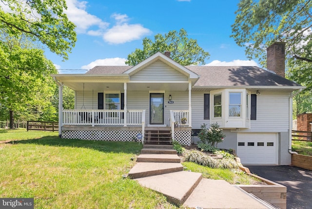 7819 Oak St, Manassas, VA 20111 - ranch-style home with a porch, an attached garage, a front yard, and a chimney