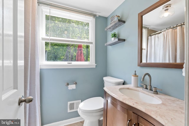 full bathroom featuring vanity, toilet, and visible vents