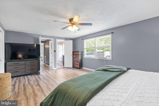 7819 Oak St, Manassas, VA 20111 - bedroom featuring connected bathroom, a textured ceiling, a ceiling fan, baseboards, and wood finished floors