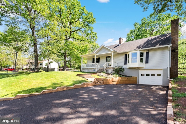 7819 Oak St, Manassas, VA 20111 - ranch-style house with a front lawn, an attached garage, a chimney, a porch, and driveway