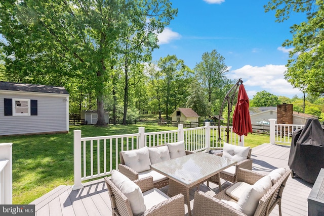 wooden deck with an outdoor structure, fence, outdoor lounge area, and a shed