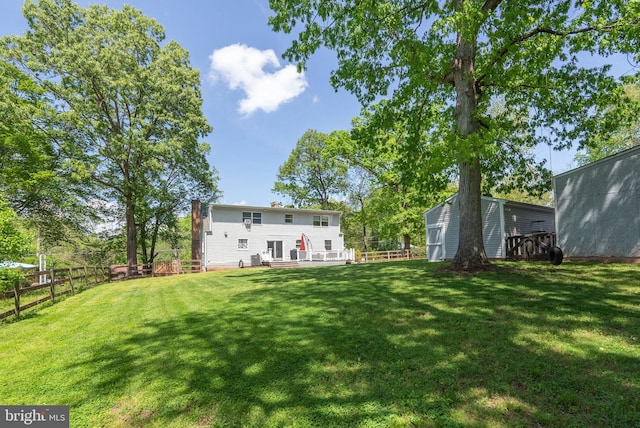 view of yard with fence and a wooden deck