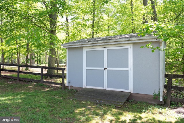 view of shed featuring fence