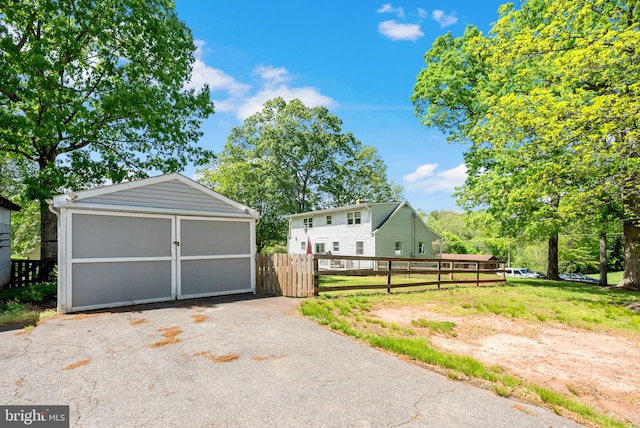 detached garage featuring fence
