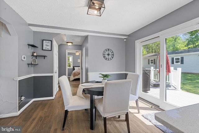 dining room with baseboards and wood finished floors