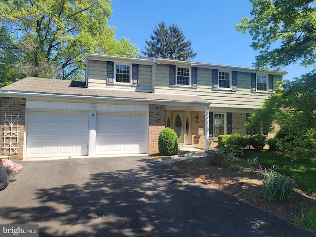 5895 Tibby Rd, Bensalem, PA 19020 - view of front of home featuring brick siding, asphalt driveway, and covered porch
