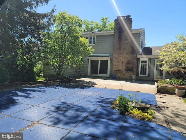 5895 Tibby Rd, Bensalem, PA 19020 - back of house featuring a patio and a chimney
