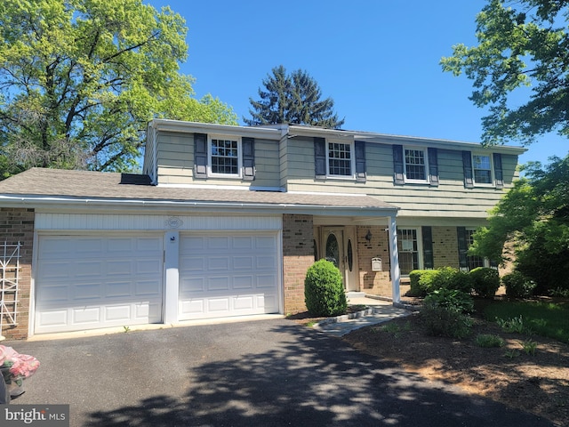 5895 Tibby Rd, Bensalem, PA 19020 - view of front of home featuring brick siding, asphalt driveway, and a shingled roof