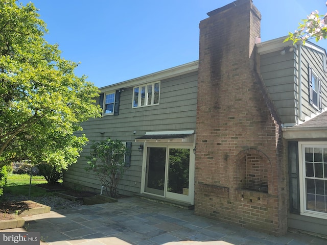 5895 Tibby Rd, Bensalem, PA 19020 - back of property with a patio area and a chimney