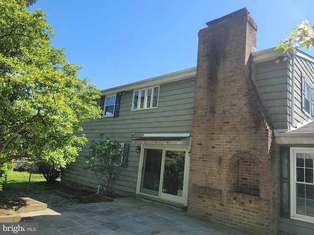 5895 Tibby Rd, Bensalem, PA 19020 - rear view of house featuring a patio and a chimney