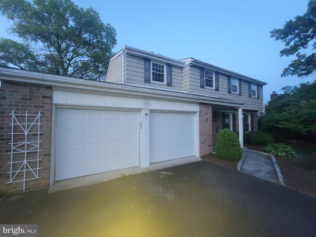 5895 Tibby Rd, Bensalem, PA 19020 - traditional-style home featuring brick siding, driveway, and a garage