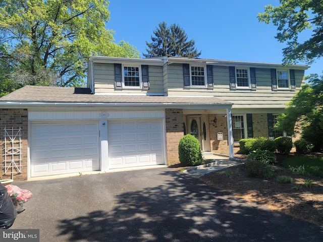 5895 Tibby Rd, Bensalem, PA 19020 - view of front of home featuring brick siding, asphalt driveway, and covered porch