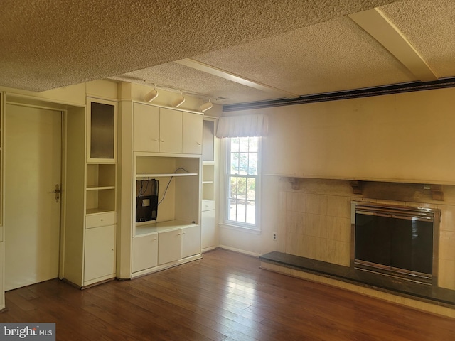 5895 Tibby Rd, Bensalem, PA 19020 - unfurnished living room featuring a textured ceiling, dark wood-style flooring, and a fireplace
