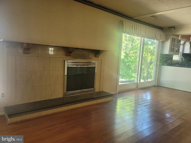 5895 Tibby Rd, Bensalem, PA 19020 - unfurnished living room with a textured ceiling and wood finished floors