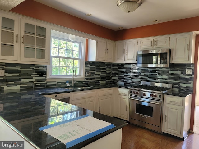 5895 Tibby Rd, Bensalem, PA 19020 - kitchen with appliances with stainless steel finishes, a sink, white cabinets, and tasteful backsplash