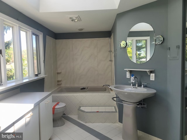 5895 Tibby Rd, Bensalem, PA 19020 - full bathroom featuring tile patterned floors, tiled bath, healthy amount of natural light, and toilet