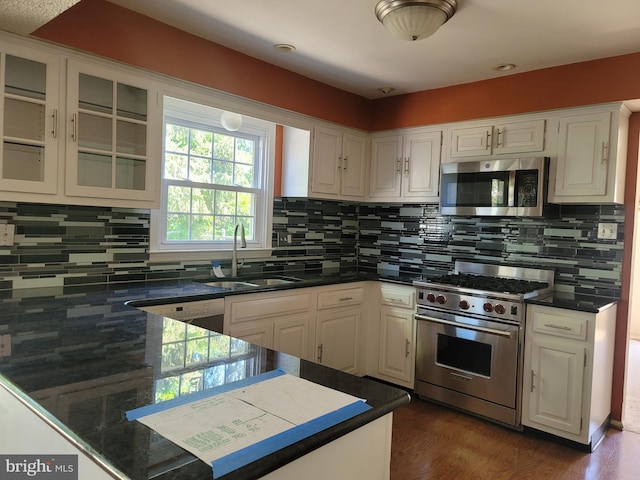 5895 Tibby Rd, Bensalem, PA 19020 - kitchen with appliances with stainless steel finishes, a sink, white cabinets, and tasteful backsplash