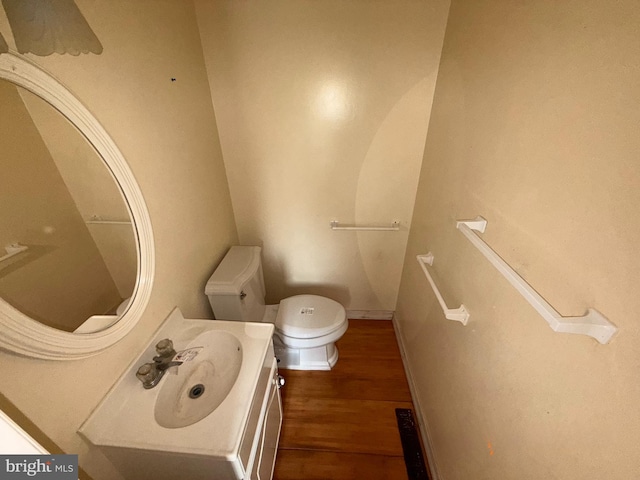 2218 Trenton Ave, Bristol, PA 19007 - half bathroom featuring toilet, vanity, and wood finished floors