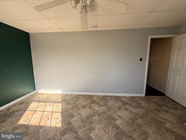 2218 Trenton Ave, Bristol, PA 19007 - empty room featuring a drop ceiling, a ceiling fan, baseboards, and stone finish floors