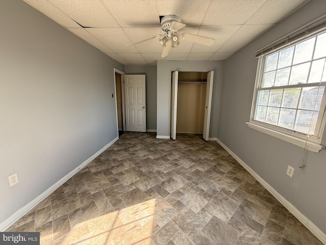 2218 Trenton Ave, Bristol, PA 19007 - unfurnished bedroom with stone finish flooring, baseboards, a drop ceiling, a closet, and a ceiling fan