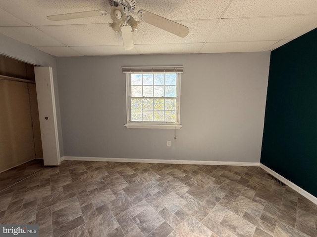 2218 Trenton Ave, Bristol, PA 19007 - unfurnished bedroom featuring a drop ceiling, stone finish flooring, baseboards, ceiling fan, and a closet
