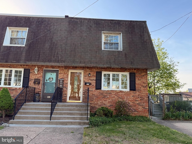 2218 Trenton Ave, Bristol, PA 19007 - view of front of property with mansard roof, brick siding, and a shingled roof