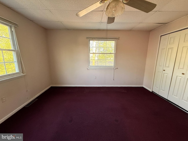 2218 Trenton Ave, Bristol, PA 19007 - unfurnished bedroom featuring multiple windows, dark carpet, and baseboards