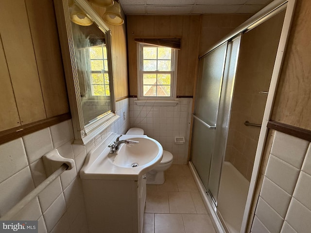 2218 Trenton Ave, Bristol, PA 19007 - bathroom featuring vanity, toilet, a shower stall, tile patterned floors, and tile walls