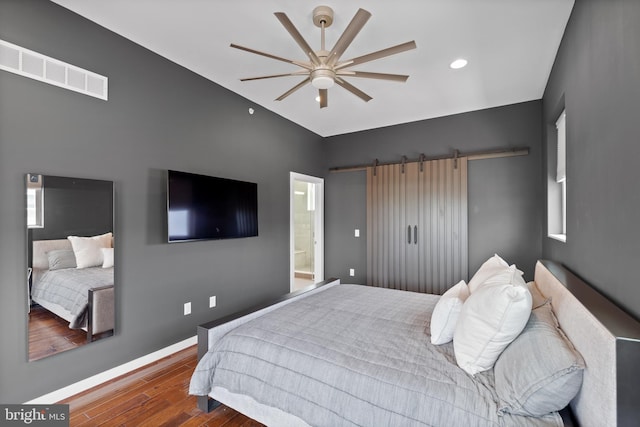 1424 S 4th St, Philadelphia, PA 19147 - bedroom featuring wood finished floors, a barn door, visible vents, vaulted ceiling, and baseboards