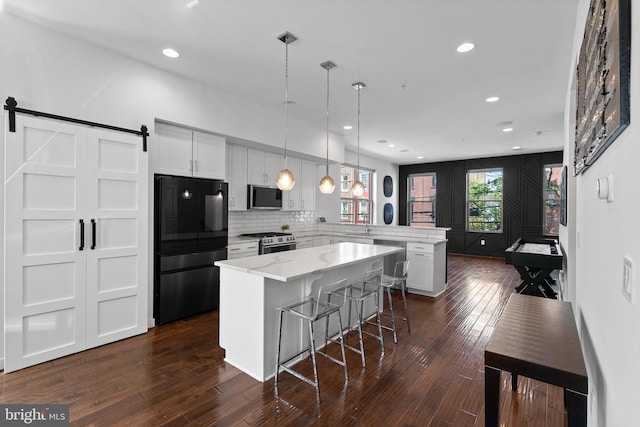 1424 S 4th St, Philadelphia, PA 19147 - kitchen with a peninsula, stainless steel appliances, recessed lighting, a kitchen bar, and a kitchen island