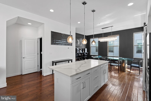 1424 S 4th St, Philadelphia, PA 19147 - kitchen featuring pendant lighting, dark wood-style flooring, light stone countertops, and a center island