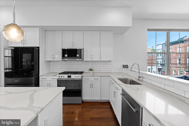 1424 S 4th St, Philadelphia, PA 19147 - kitchen with a sink, tasteful backsplash, dark wood-style flooring, white cabinetry, and appliances with stainless steel finishes