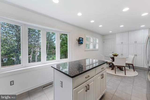 817 Golden Arrow St, Great Falls, VA 22066 - kitchen with light tile patterned floors, recessed lighting, white cabinetry, and dark stone counters