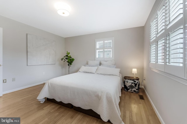 817 Golden Arrow St, Great Falls, VA 22066 - bedroom with light wood-style flooring and baseboards