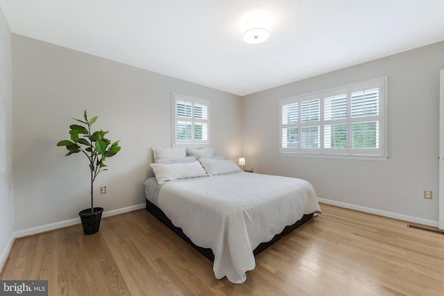 817 Golden Arrow St, Great Falls, VA 22066 - bedroom featuring baseboards and light wood-style flooring