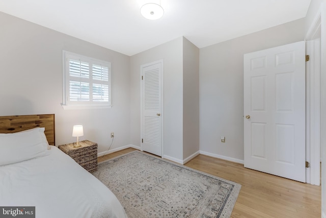 817 Golden Arrow St, Great Falls, VA 22066 - bedroom with light wood-type flooring, baseboards, and a closet