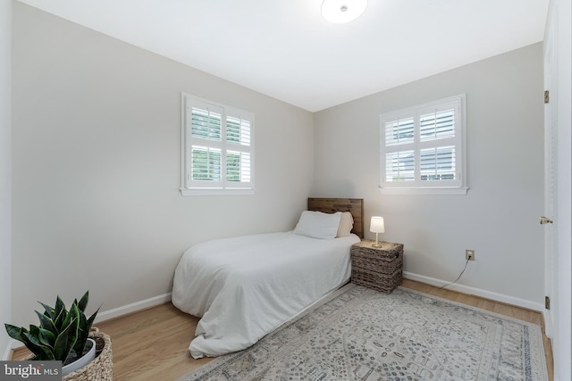 817 Golden Arrow St, Great Falls, VA 22066 - bedroom with wood finished floors, multiple windows, and baseboards