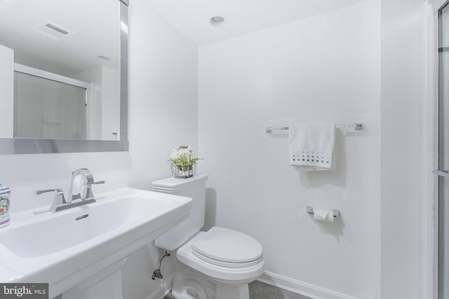 817 Golden Arrow St, Great Falls, VA 22066 - bathroom featuring toilet, a sink, an enclosed shower, and baseboards