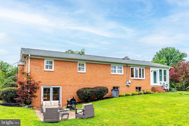 817 Golden Arrow St, Great Falls, VA 22066 - rear view of property featuring entry steps, a lawn, brick siding, and an outdoor living space