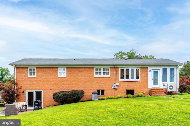 817 Golden Arrow St, Great Falls, VA 22066 - rear view of house with a cooling unit, a lawn, and brick siding