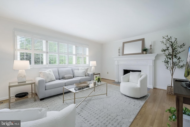 817 Golden Arrow St, Great Falls, VA 22066 - living room featuring wood finished floors, a fireplace with flush hearth, and baseboards
