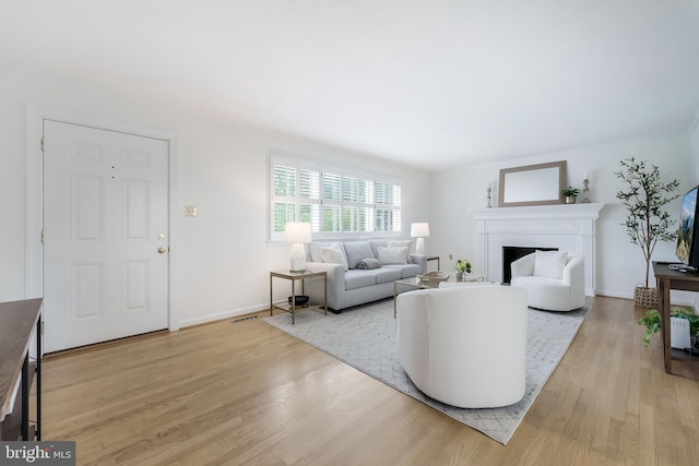 817 Golden Arrow St, Great Falls, VA 22066 - living room with light wood-style floors, a fireplace, and baseboards