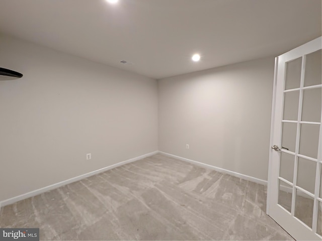 spare room featuring recessed lighting, baseboards, and light carpet