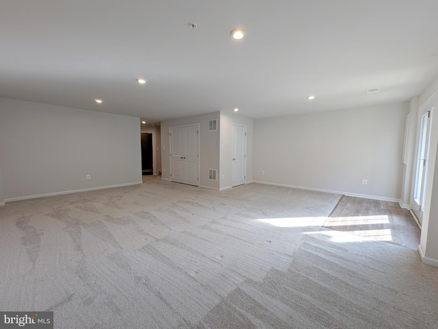 interior space with visible vents, recessed lighting, baseboards, and light carpet
