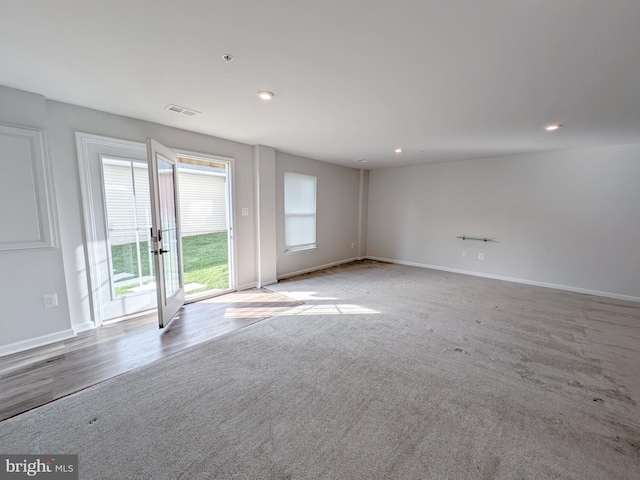 carpeted empty room featuring visible vents, recessed lighting, and baseboards