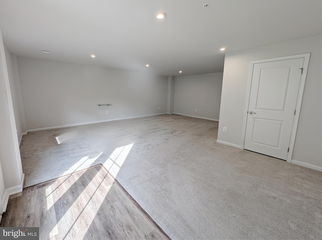 unfurnished room featuring recessed lighting, baseboards, and light colored carpet