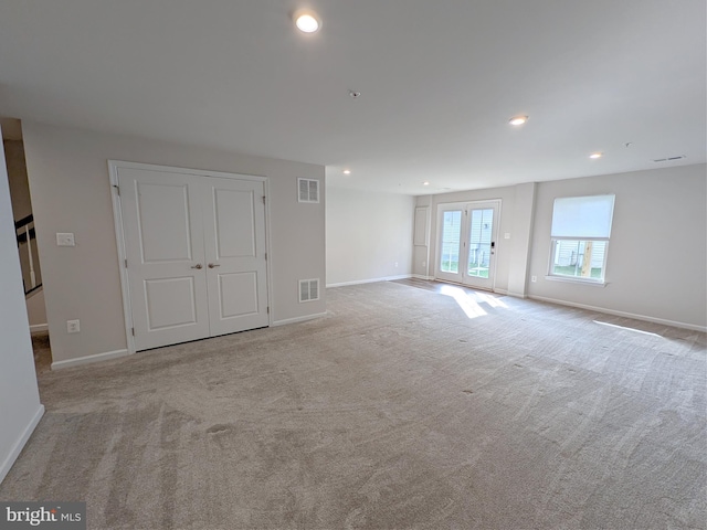 unfurnished room with visible vents, baseboards, and carpet floors